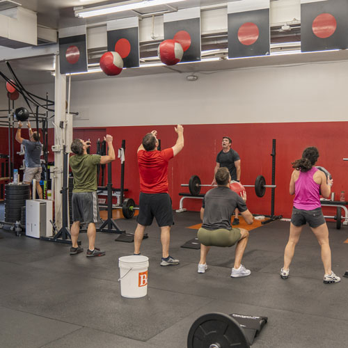 CrossFit Kirkwood CrossFit classes - members throwing wall balls